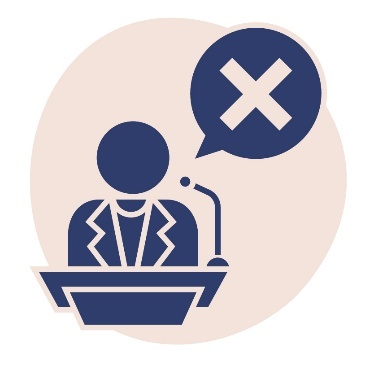 A person behind a podium with a microphone. Above them is a speech bubble that shows a cross.
