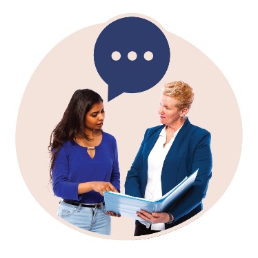 2 people looking at a document together. 1 of them has a speech bubble.